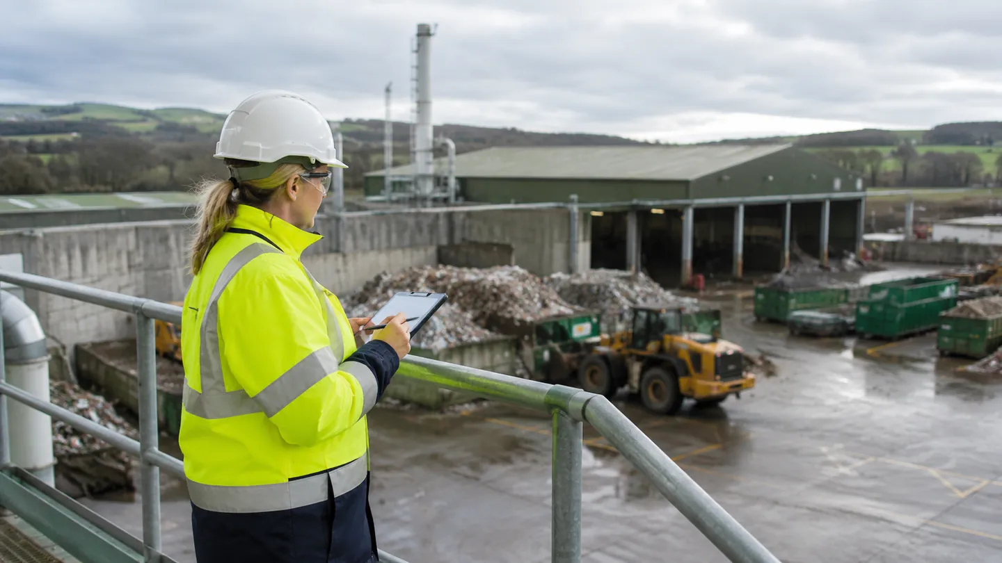 Environmental consultant reviewing compliance at an industrial facility.